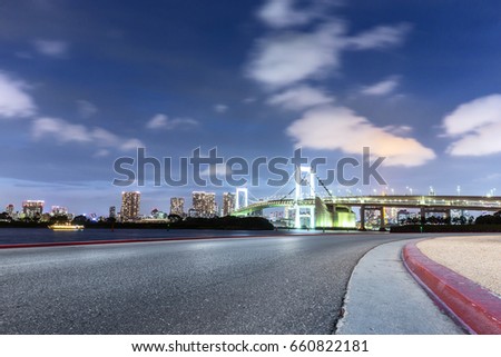 empty road with suspension bridge in tokyo against cloud sky at twilight 