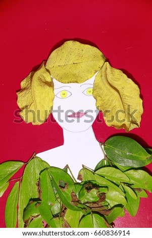 the green eyes red lip yellow hair and green suit made of paper and leaves on red background