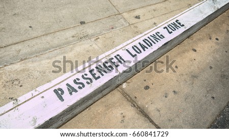 Passenger loading zone stencil on the sidewalk