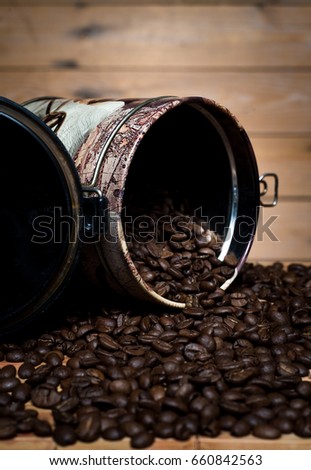 Tin of coffee and beans od wooden table