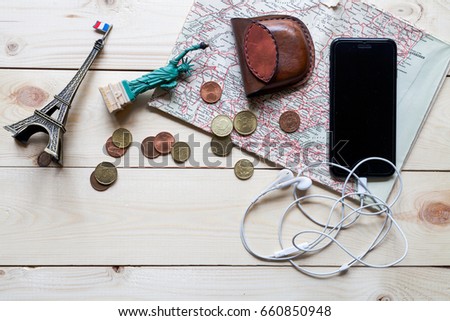 Travel concept - map, coins, the tablet, headphones. Top view 
