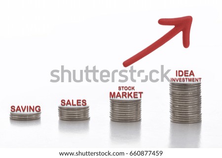 Stack of coins with tool for rich words and red arrow on white background, business success concept and growth idea