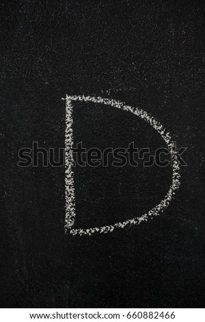 Letter D drawn with white chalk on blackboard. Education, school concept