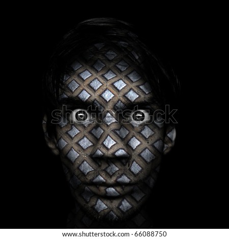 Man with serious dark stare and metal texture on his face.