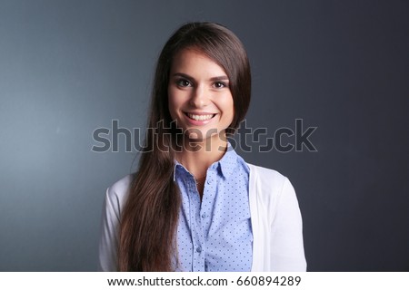 Portrait of a businesswoman , against dark background. Woman smi Royalty-Free Stock Photo #660894289