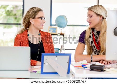 Two office workers at the desk