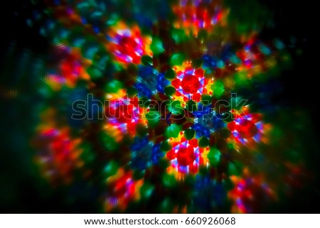 Abstract pattern inside of kaleidoscope Real photo. Little pieces of glass are mixed in one geometric ornament. Colorful vivid kaleidoscope pattern - repetition, emotion, chakra, mandala, energy theme