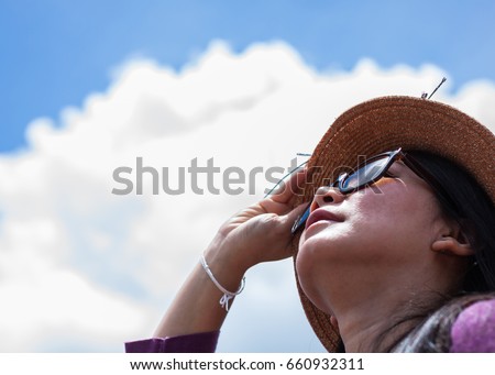 asian women wear sunglasses with sunlight rays Royalty-Free Stock Photo #660932311