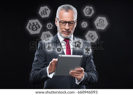 Senior businessman using digital tablet and business hexagon icons around