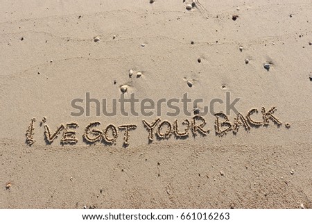 Handwriting  words "I'VE GOT YOUR BACK." on sand of beach. Royalty-Free Stock Photo #661016263