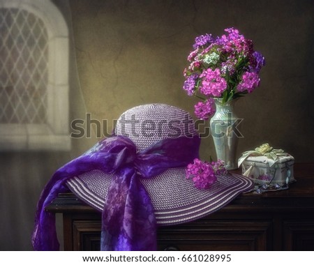 Still life with flowers and a hat