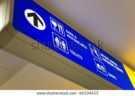 Detailed  view of blue airport sign showing directions.