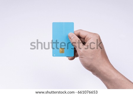 A hand holding a credit card