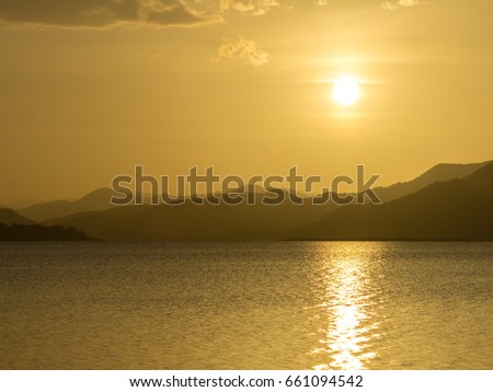 Sunset in the lake with layers of the mountain.