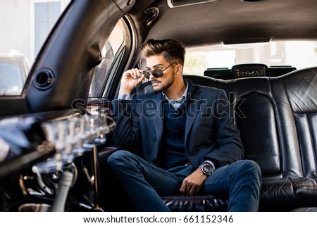 Young attractive business man in limousine