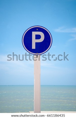 Parking sign and sea background with blue sky
