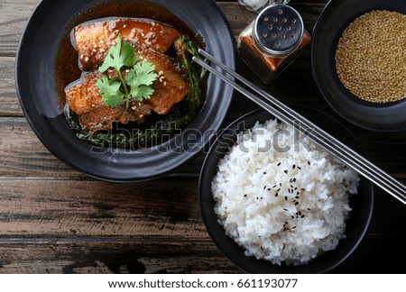 Chinese sweet steamed pork  setting on black japanese style plate in studio lighting.
