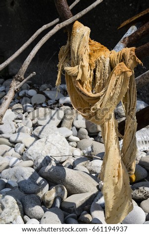 Side Angle View Of Washed-Up Woven Fabric On Greek Beach