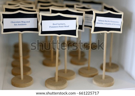 small wooden signages with variety of food names cutting