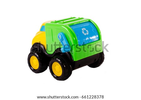 Children's plastic toy garbage truck isolated on white background. Backside view, studio photo.