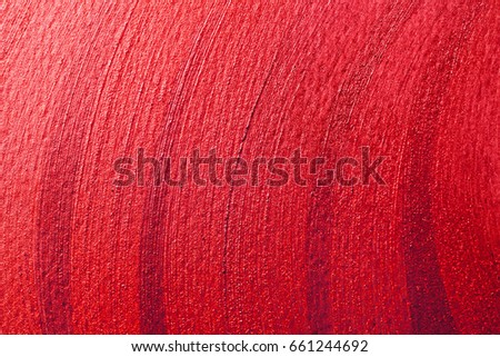 Red shining stroke texture made with brush and paint hand drawn. Golden abstract background. Perfect festive backdrop