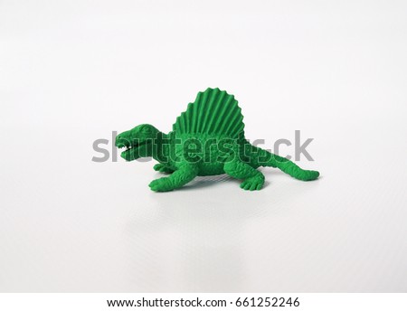 Spinosaurus dinosaur model made from green rubber isolated on white background.  
