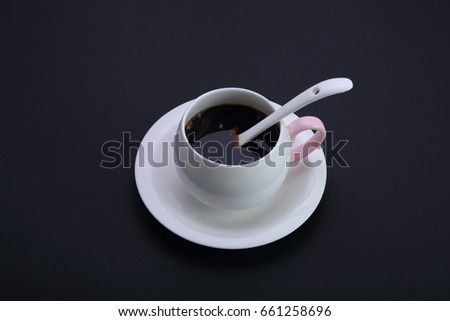 a cup of ginger tea  on the black background