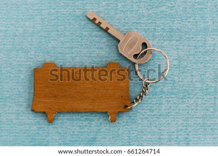 key and wooden sign on the blue tile floor