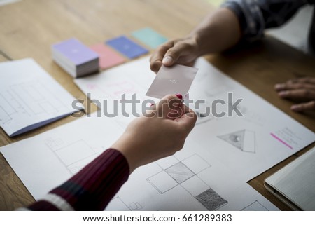 Hands holding wifi card with drawing design paper