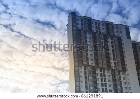 Condominium or apartment building with sun light sky and cloud in the morning.