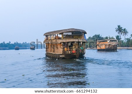 Houseboats sailing in the backwaters of Alappuzha, Kerala India.