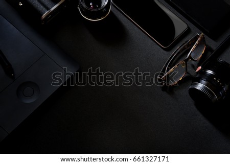Designer desk mockup. Desk, Camera - Photographic Equipment, Smart Phone on dark top table.