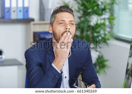 young businessman yawning