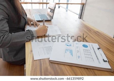 Lady signing a contract