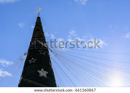 Low Angle View of Decorated Christmas Tree Against Blue Sky
