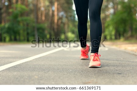 Crop image. Legs of young fitness woman running outdoor.	