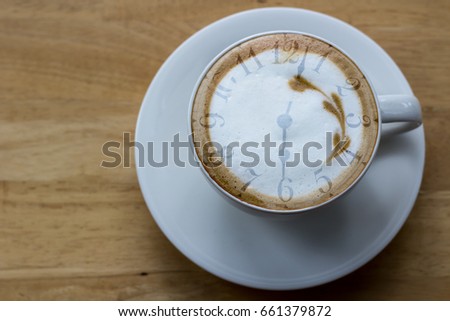 Abstract image of good morning with time on top of cappuccino coffee 