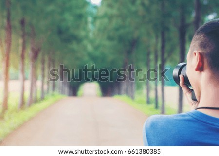 Man Camera  take photos in park with sunset. Photography Concept