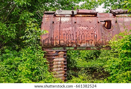 Old railway wagon captured by vegetation.