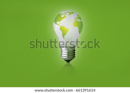 Energy saving light bulb with a world map on a green background.  Place for the text.