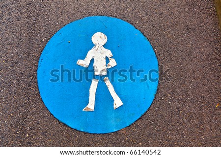 symbol for pathway and icon for pedestrians on asphalt