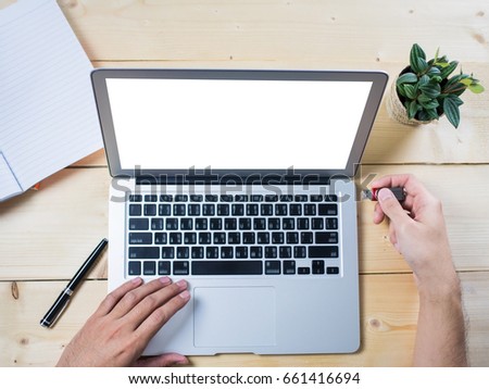 Insert use and eject thumb drive with computer notebook on wooden table, top view Royalty-Free Stock Photo #661416694