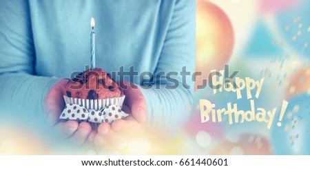 Kid boy holding birthday cake with candle, closeup