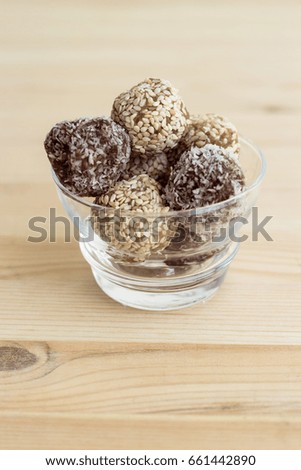 Homemade healthy paleo dates and chocolate energy balls. Vegan truffles. Copy space. Soft toned photo