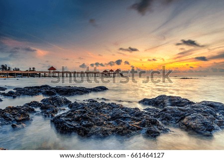 Beautiful long exposure sunrise shot at jetty. Image contain certain grain or noise and soft focus when view at full resolution