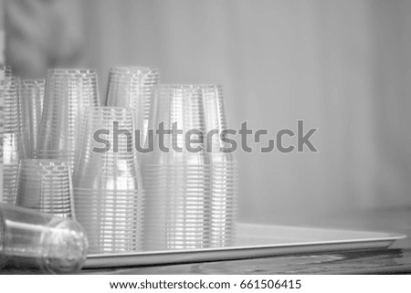 pile of plastic glass on dish, black and white picture with copy space