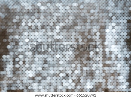 Silver white glittering Christmas lights. Blurred abstract background.