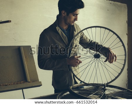 Male technician in his bicycle repair shop