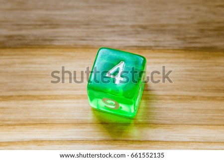 A beautiful winning playing dice rolled on a side on wooden table
