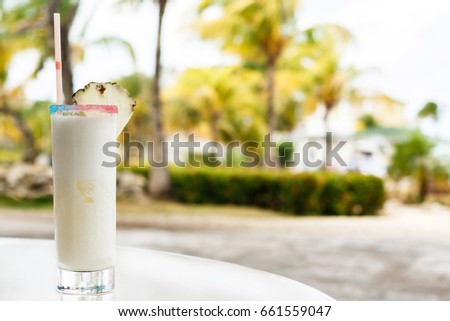 Glass of Pina colada cocktail on the table